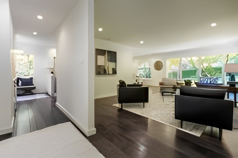 Modern living room with dark wood flooring.