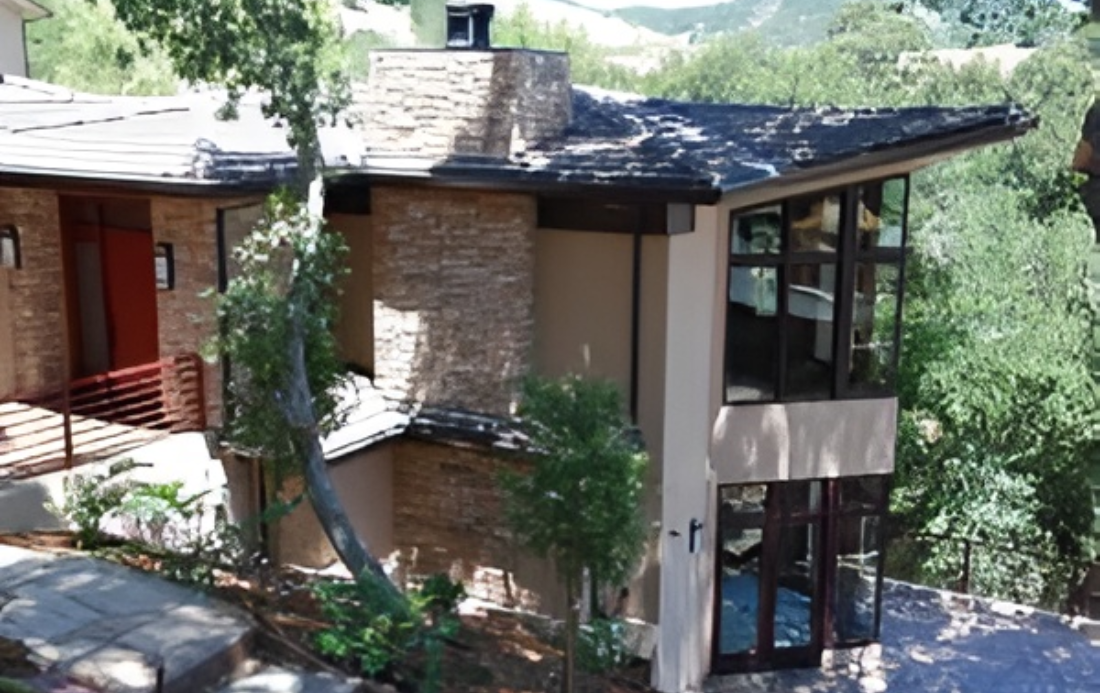 Modern house with stone and glass exterior.