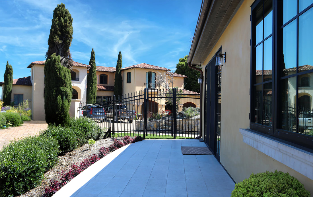 Mediterranean-style villa with garden and pathway.