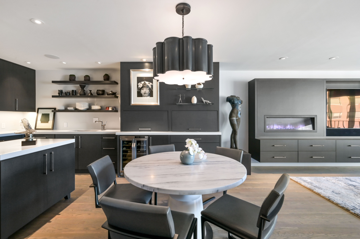 Modern kitchen and dining area with fireplace.