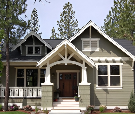 Green craftsman house with front porch.