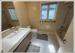 Small bathroom with vanity, toilet, bathtub
