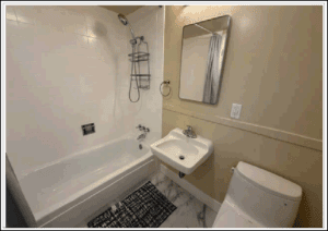 Small bathroom with tub, sink, and toilet