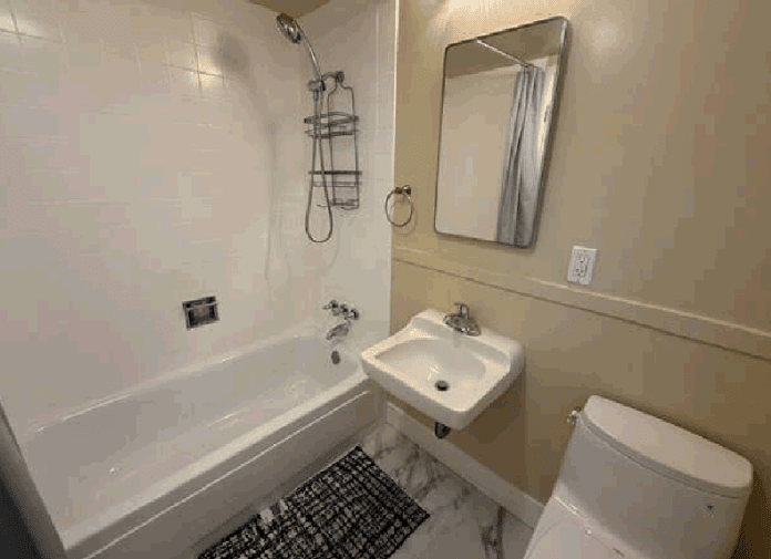 Small bathroom with tub, sink, and toilet