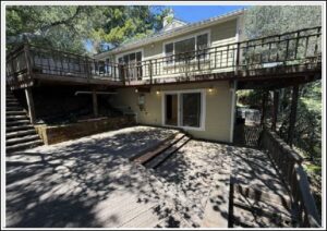 Two-story house with large wooden deck