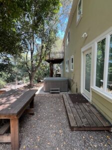 Back patio with picnic table and hot tub