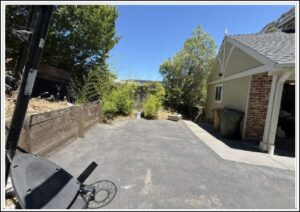Residential driveway with garage and trees