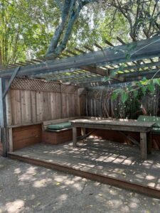 Shaded wooden pergola with bench seating