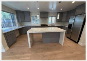 Modern kitchen with marble island and gray cabinets