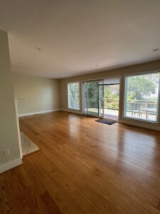 Empty living room, hardwood floors, sliding glass door