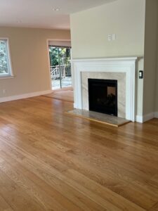Empty living room with hardwood floors and fireplace
