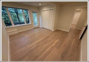 Empty bedroom with hardwood floors and closet