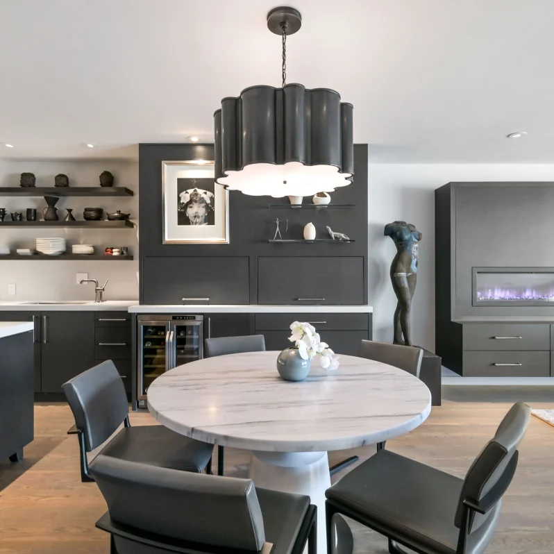 Modern kitchen and dining area with fireplace.